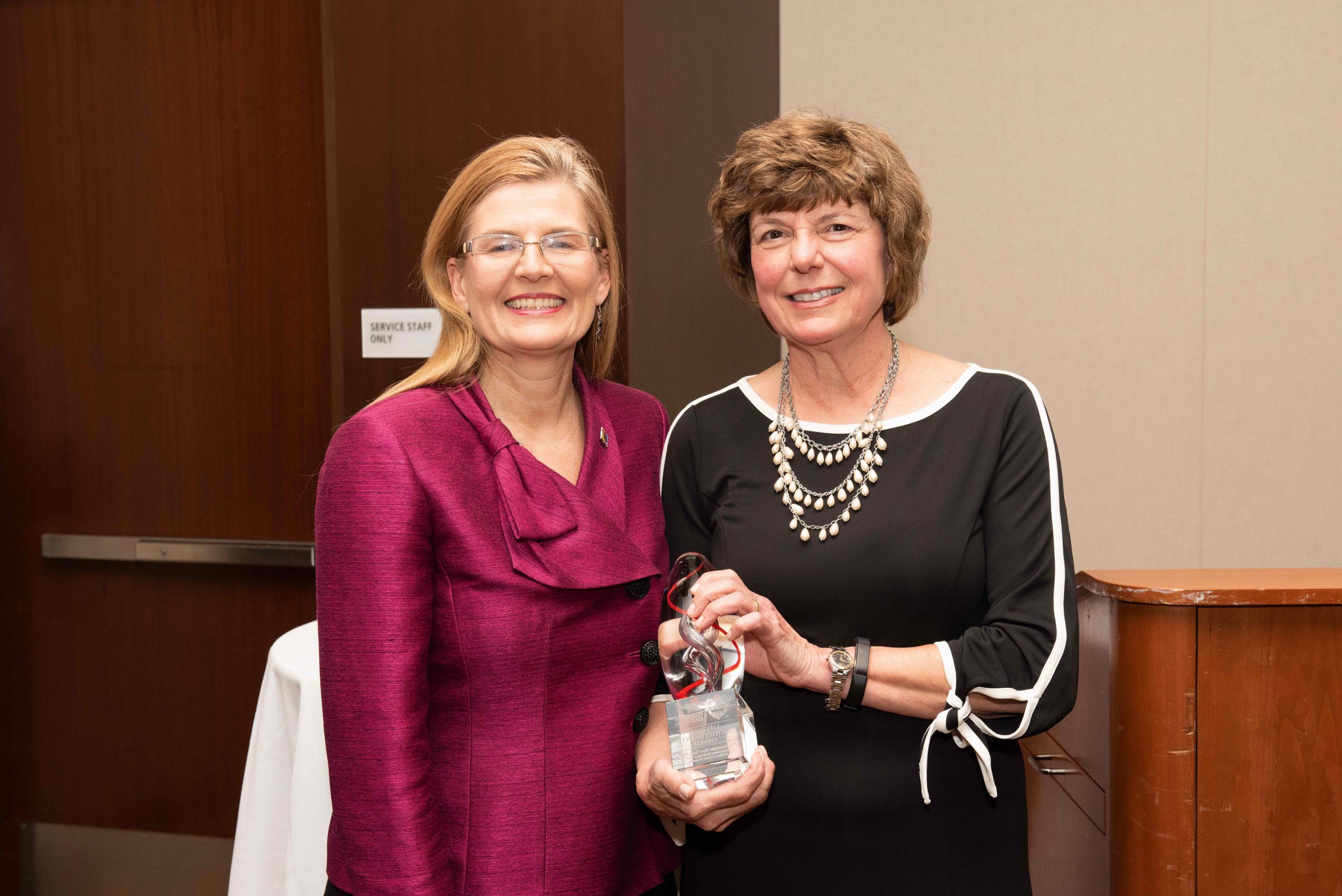 CARE Board Chair Lynn Tavenner presents the CARE Lifetime Achievement Award to Hon. Mary Grace Diehl (N.D. Ga.).