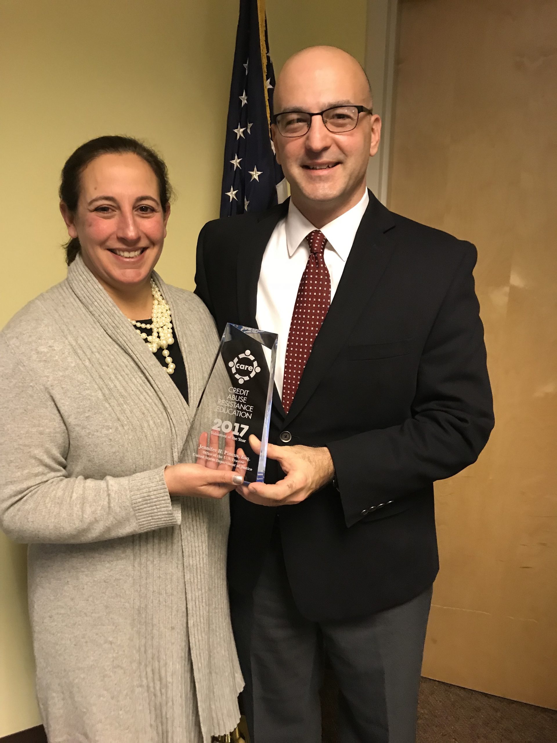 CARE Maine Coordinator Jennifer Pincus (U.S. Department of Justice, Office of the U.S. Trustee) receives the 2018 CARE Volunteer of the Year Award from Judge Michael Fagone (U.S. Bankruptcy Court, District of Maine). Judge Fagone accepted the award on her behalf in November 2017.